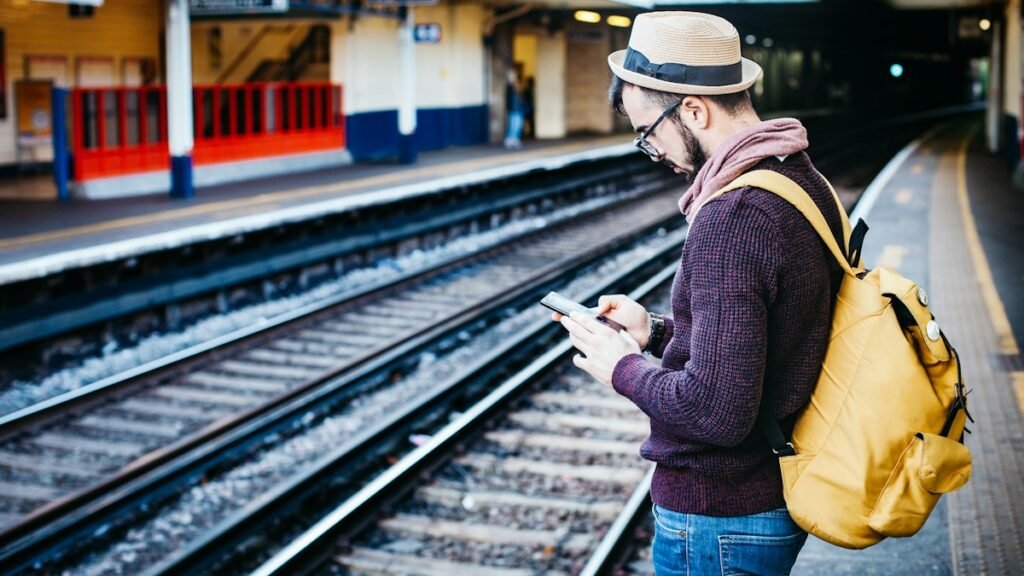 30 Day SIM Only Plans From 5GB to Unlimited Data Traveller using a smartphone on a railway platform