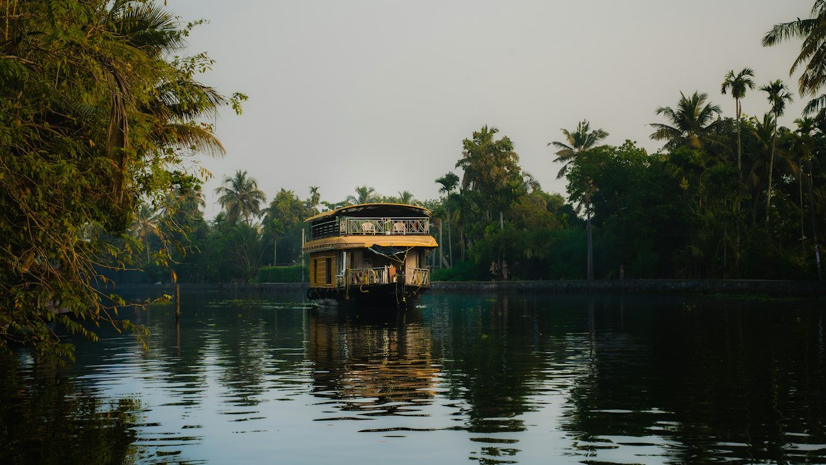 Houseboat gliding along the palm-lined backwaters of Kerala